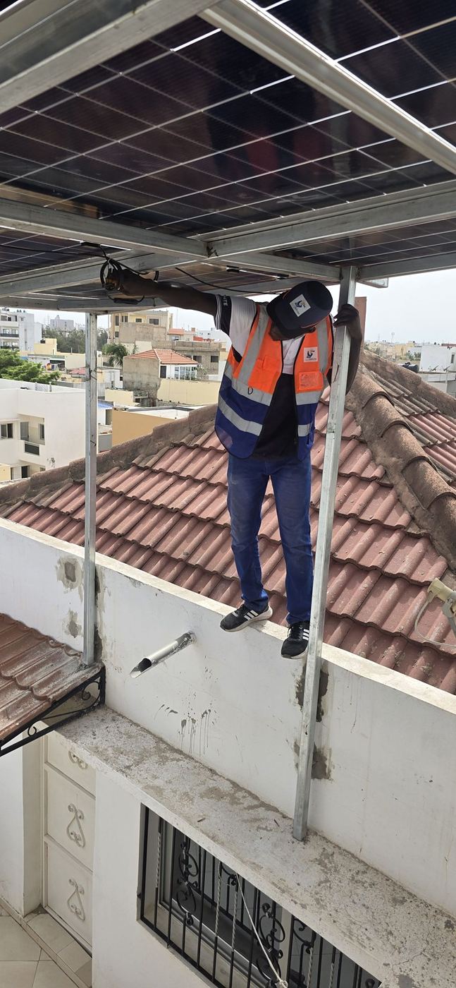 Un apprenant sur une toiture équipée de panneaux